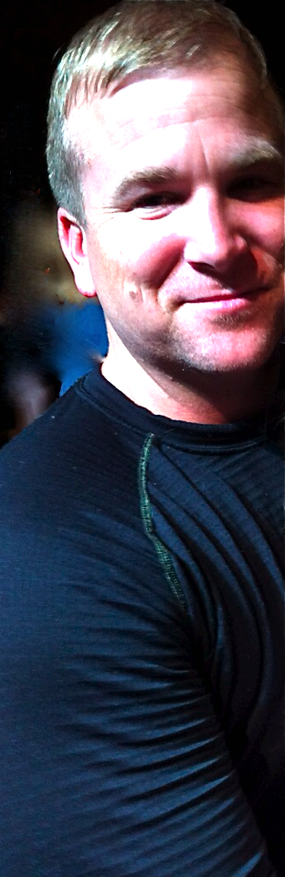Smiling man in a dark athletic shirt