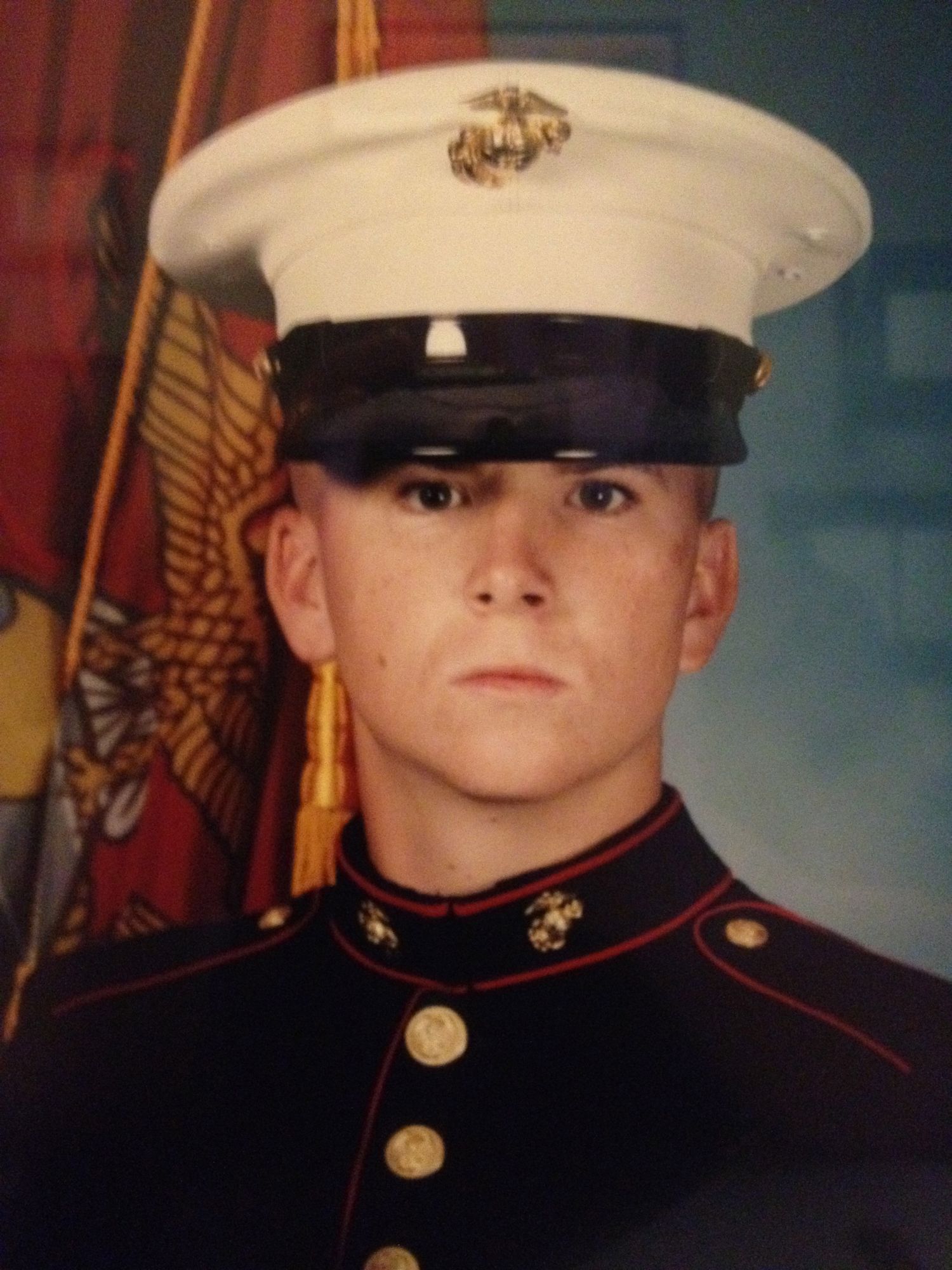 Portrait of a young man in a Marine Corps dress blue uniform and white cover